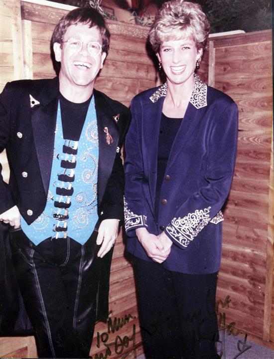 Sir Elton John: A colour photograph of Sir Elton John and Diana Princess of Wales, 10 x 8in., housed in a silver photograph frame, over